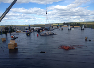 equipe-installe-membrane-sur-tres-grande-surface-avec-aide-de-camion-grue-resiflex-centre-du-quebec