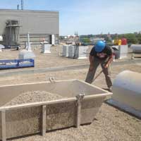 specialiste-installe-du-gravier-pour-entretien-sur-couverture-de-toit-plat-resiflex-lanaudiere